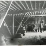 Men in Barn with Feed Bags